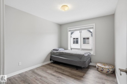Bedroom with light wood-type flooring and a textured ceiling - 90 1010 Rabbit Hill Road, Edmonton, AB - Indoor Photo Showing Bedroom