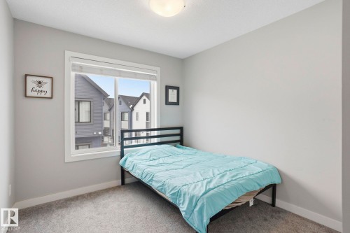Carpeted bedroom featuring baseboards - 90 1010 Rabbit Hill Road, Edmonton, AB - Indoor Photo Showing Bedroom