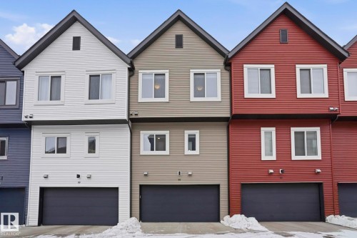 View of front of home with a garage and concrete driveway - 90 1010 Rabbit Hill Road, Edmonton, AB - Outdoor With Facade