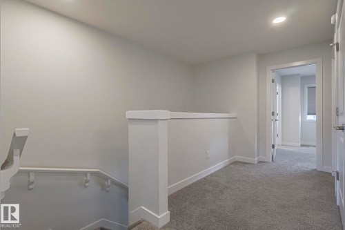 Corridor with an upstairs landing, light carpet, and recessed lighting - 3520 Kulay Link Link, Edmonton, AB - Indoor Photo Showing Other Room