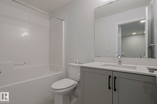 Bathroom featuring vanity and shower / tub combination - 3520 Kulay Link Link, Edmonton, AB - Indoor Photo Showing Bathroom