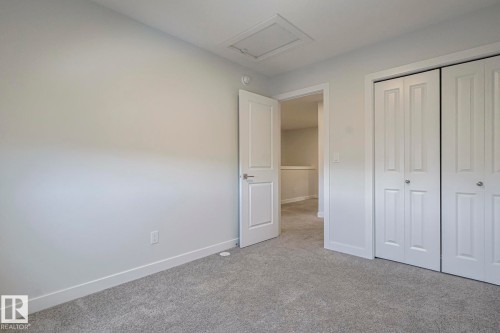 Unfurnished bedroom featuring carpet flooring and a closet - 3520 Kulay Link Link, Edmonton, AB - Indoor