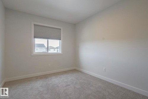 Unfurnished room with light colored carpet and baseboards - 3520 Kulay Link Link, Edmonton, AB - Indoor Photo Showing Other Room