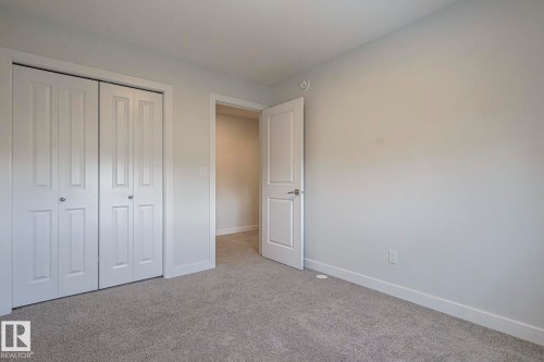 Unfurnished bedroom with carpet floors and a closet - 3520 Kulay Link Link, Edmonton, AB - Indoor