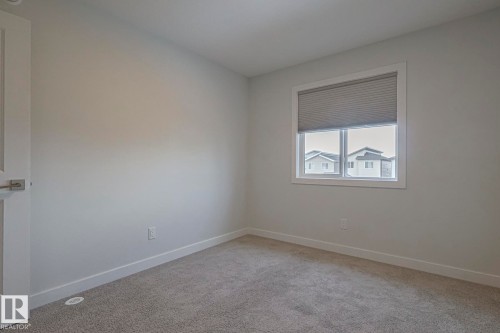 Unfurnished room with light colored carpet and baseboards - 3520 Kulay Link Link, Edmonton, AB - Indoor Photo Showing Other Room