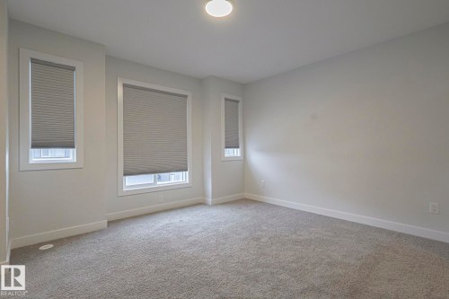 Spare room featuring light colored carpet and baseboards - 3520 Kulay Link Link, Edmonton, AB - Indoor Photo Showing Other Room