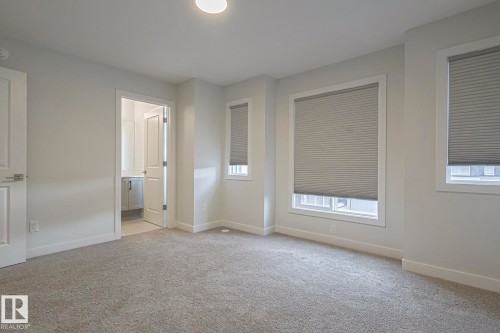 Unfurnished bedroom featuring light carpet and ensuite bathroom - 3520 Kulay Link Link, Edmonton, AB - Indoor