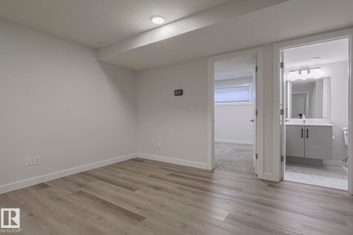 Spare room with baseboards and light wood finished floors - 3520 Kulay Link Link, Edmonton, AB - Indoor Photo Showing Other Room