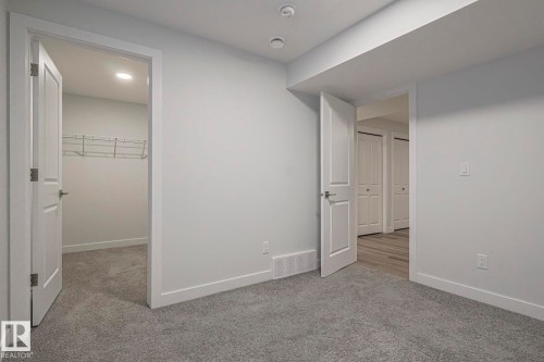 Unfurnished bedroom with a spacious closet and light carpet - 3520 Kulay Link Link, Edmonton, AB - Indoor Photo Showing Other Room