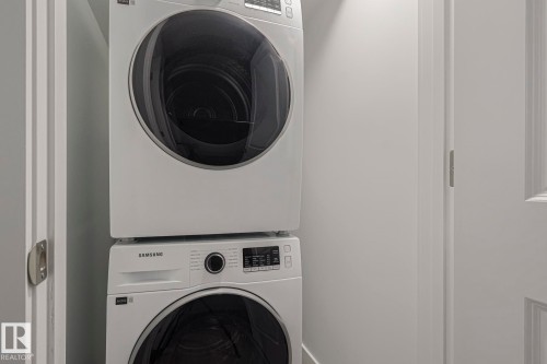 Laundry area featuring stacked washing machine and dryer - 3520 Kulay Link Link, Edmonton, AB - Indoor Photo Showing Laundry Room