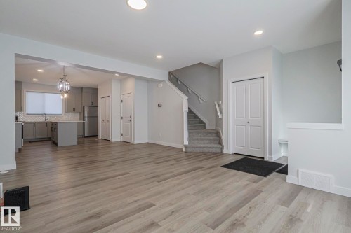 Unfurnished living room with light wood-style floors and a chandelier - 3520 Kulay Link Link, Edmonton, AB - Indoor