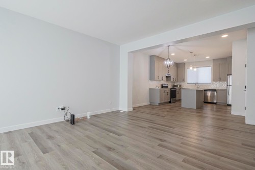 Unfurnished living room featuring dark wood-type flooring and recessed lighting - 3520 Kulay Link Link, Edmonton, AB - Indoor Photo Showing Living Room