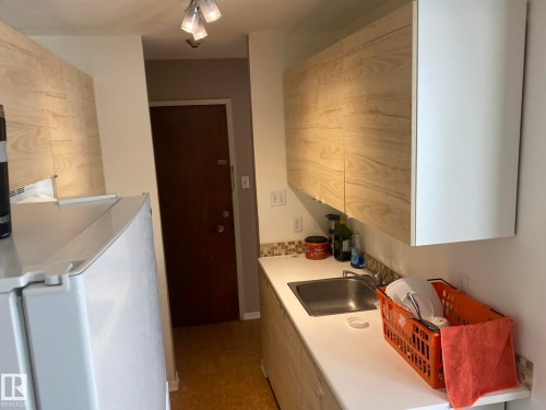 Kitchen with light countertops and white fridge - 205 10345 123 Street, Edmonton, AB - Indoor Photo Showing Kitchen
