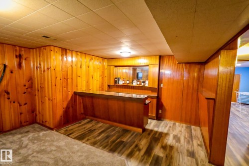 Indoor dry bar featuring dark wood finished floors and wooden walls - 4812 51 Avenue, Vilna, AB - Indoor Photo Showing Other Room