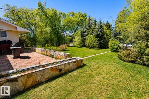 Patio featuring paver flooring and stone retaining walls - 4812 51 Avenue, Vilna, AB - Outdoor