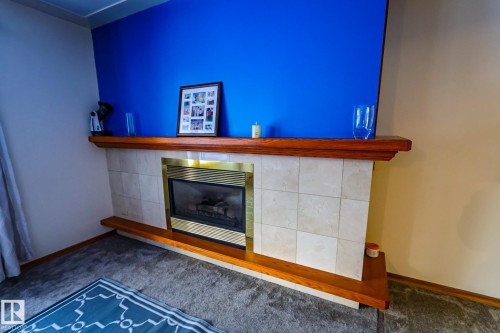 Detailed view of carpet and a fireplace - 4812 51 Avenue, Vilna, AB - Indoor With Fireplace