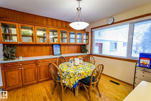 Dining space with light wood-style flooring and wood walls - 4812 51 Avenue, Vilna, AB - Indoor Photo Showing Dining Room