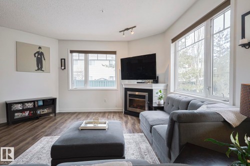 111 2035 Grantham Crest Nw, Edmonton, AB - Indoor Photo Showing Living Room With Fireplace