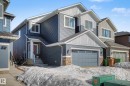 Craftsman-style home with board and batten siding, stone siding, a shingled roof, and an attached garage - 34 Riverhill Crescent, St. Albert, AB  - Outdoor With Facade 