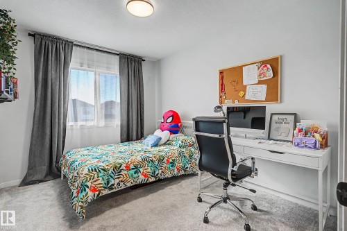 Bedroom with light carpet and an office area - 34 Riverhill Crescent, St. Albert, AB - Indoor Photo Showing Bedroom