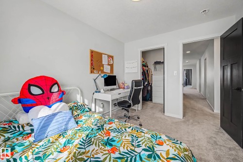 Bedroom featuring a desk, a spacious closet, and light carpet - 34 Riverhill Crescent, St. Albert, AB - Indoor