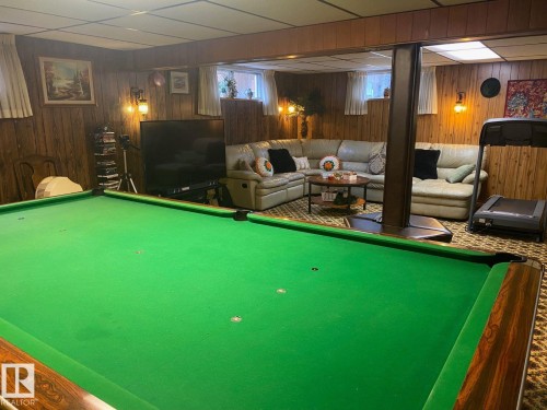 Game room featuring pool table, a paneled ceiling, and wood walls - 206 Wolf Willow Crescent, Edmonton, AB - Indoor Photo Showing Basement