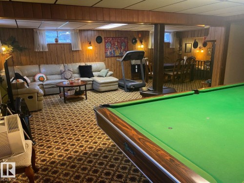 Game room with billiards table, carpet floors, and wood walls - 206 Wolf Willow Crescent, Edmonton, AB - Indoor