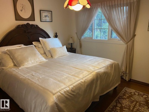 Bedroom with dark wood finished floors and baseboards - 206 Wolf Willow Crescent, Edmonton, AB - Indoor Photo Showing Bedroom