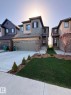 Craftsman inspired home with a garage, a lawn, concrete driveway, and stone siding - 15 Chambery Crescent, St. Albert, AB  - Outdoor With Facade 