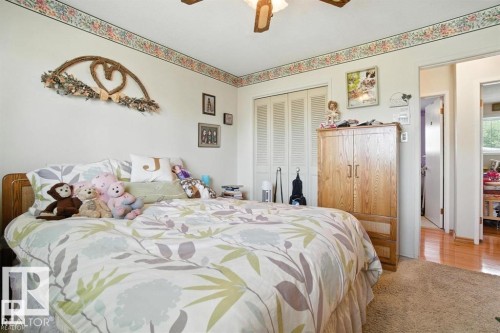 Bedroom with light colored carpet, a closet, and a ceiling fan - 14936 81 Street, Edmonton, AB - Indoor Photo Showing Bedroom