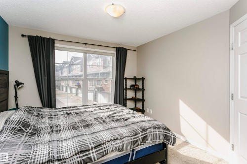 Bedroom featuring light colored carpet and a textured ceiling - 4011 Orchards Drive, Edmonton, AB - Indoor Photo Showing Bedroom