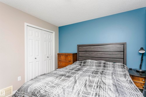 Bedroom featuring a textured ceiling and a closet - 4011 Orchards Drive, Edmonton, AB - Indoor Photo Showing Bedroom