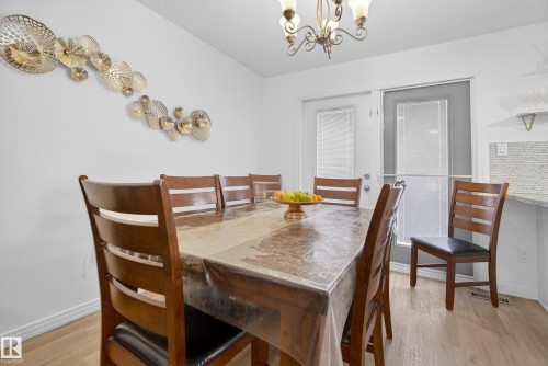 Dining room featuring light wood-style flooring and a chandelier - 17303 101 Street, Edmonton, AB - Indoor Photo Showing Dining Room
