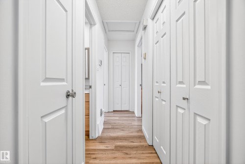 Hallway featuring a textured ceiling and light wood-type flooring - 17303 101 Street, Edmonton, AB - Indoor Photo Showing Other Room