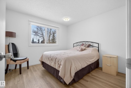 Bedroom with light wood-style flooring and a textured ceiling - 17303 101 Street, Edmonton, AB - Indoor Photo Showing Bedroom