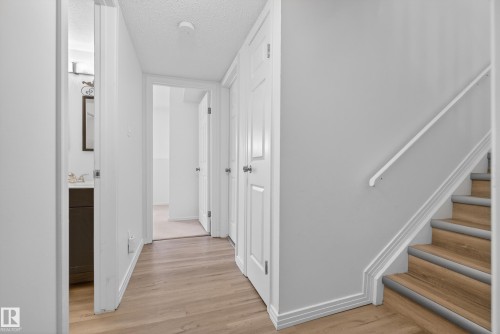 Hallway with a textured ceiling and light wood-style floors - 17303 101 Street, Edmonton, AB - Indoor Photo Showing Other Room
