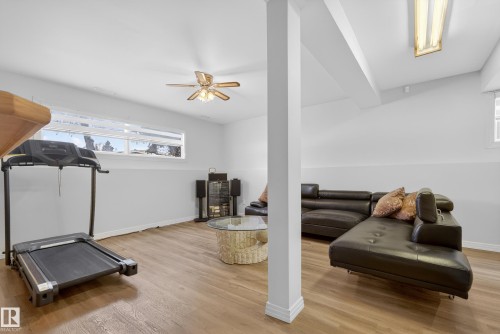 Exercise area featuring light wood finished floors and a ceiling fan - 17303 101 Street, Edmonton, AB - Indoor Photo Showing Gym Room