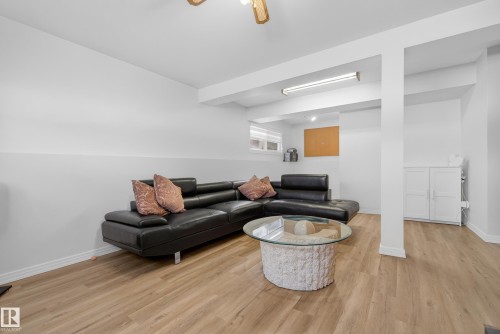 Living area featuring light wood-style flooring and ceiling fan - 17303 101 Street, Edmonton, AB - Indoor