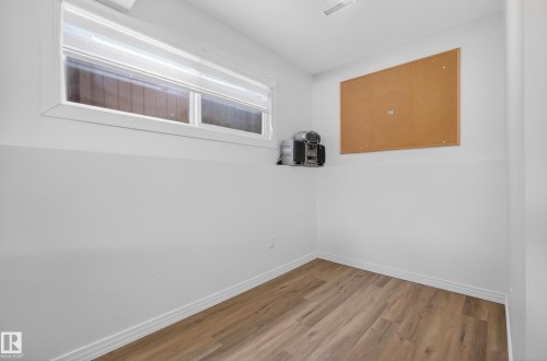 Spare room with baseboards and light wood-style flooring - 17303 101 Street, Edmonton, AB - Indoor Photo Showing Other Room
