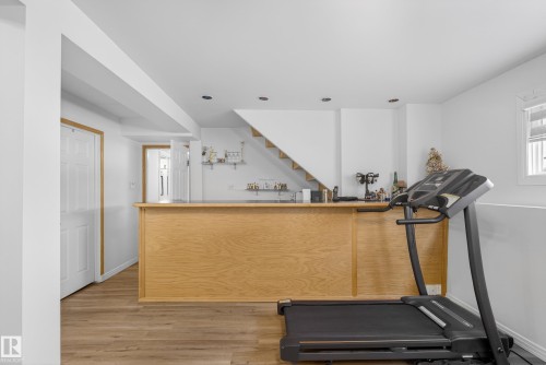 Workout room featuring a bar and light wood-type flooring - 17303 101 Street, Edmonton, AB - Indoor Photo Showing Gym Room