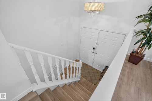 Entrance foyer with stairway and wood finished floors - 17303 101 Street, Edmonton, AB - Indoor Photo Showing Other Room