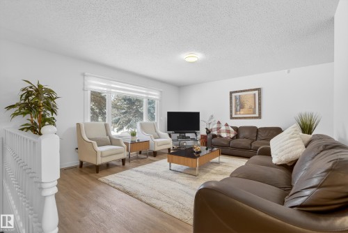Living room with light wood-type flooring and a textured ceiling - 17303 101 Street, Edmonton, AB - Indoor Photo Showing Living Room
