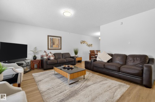 Living area with a textured ceiling and light wood-style flooring - 17303 101 Street, Edmonton, AB - Indoor Photo Showing Living Room