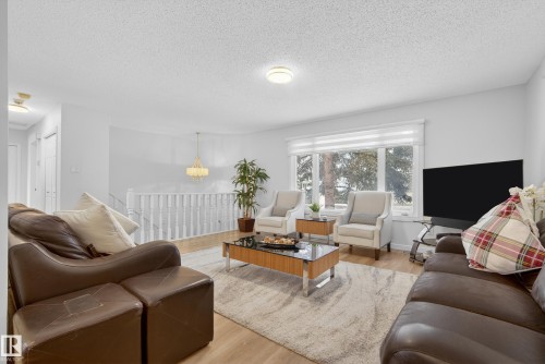 Living area with light wood-style flooring and a textured ceiling - 17303 101 Street, Edmonton, AB - Indoor Photo Showing Living Room