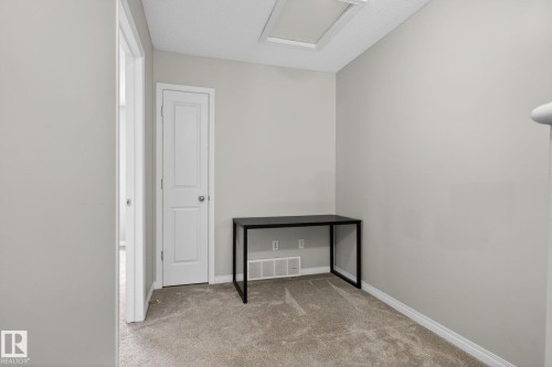 Empty room with light colored carpet and baseboards - 60 1804 70 Street, Edmonton, AB - Indoor Photo Showing Other Room