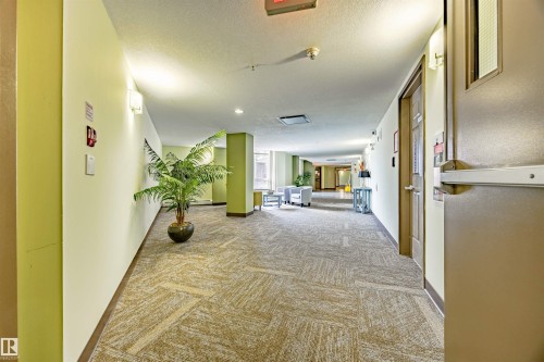 Hallway with light carpet and a textured ceiling - 132 6220 134 Avenue, Edmonton, AB - Indoor Photo Showing Other Room