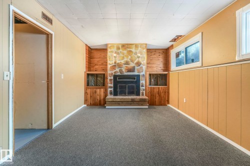 58 Huron Street S, Devon, AB - Indoor Photo Showing Other Room With Fireplace