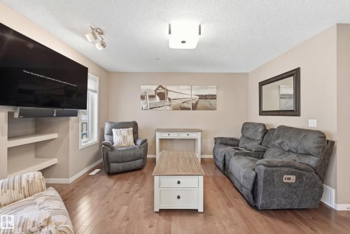 Living area featuring light wood-type flooring and a textured ceiling - 2031 Westerra Loop, Stony Plain, AB - Indoor Photo Showing Living Room