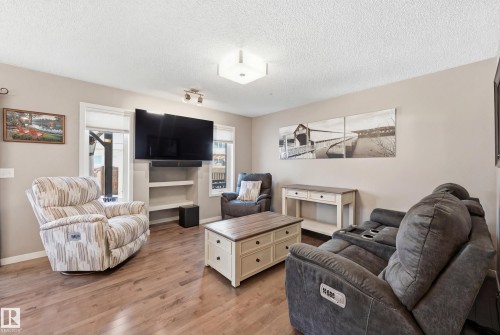 Living room featuring light wood-type flooring and a textured ceiling - 2031 Westerra Loop, Stony Plain, AB - Indoor Photo Showing Living Room