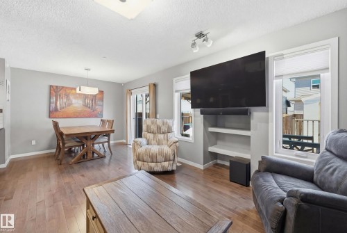 Living area with light wood-style flooring and a textured ceiling - 2031 Westerra Loop, Stony Plain, AB - Indoor Photo Showing Living Room